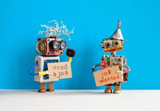 two robots hold up signs advertising for jobs