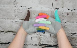Two hands painted in bright colours