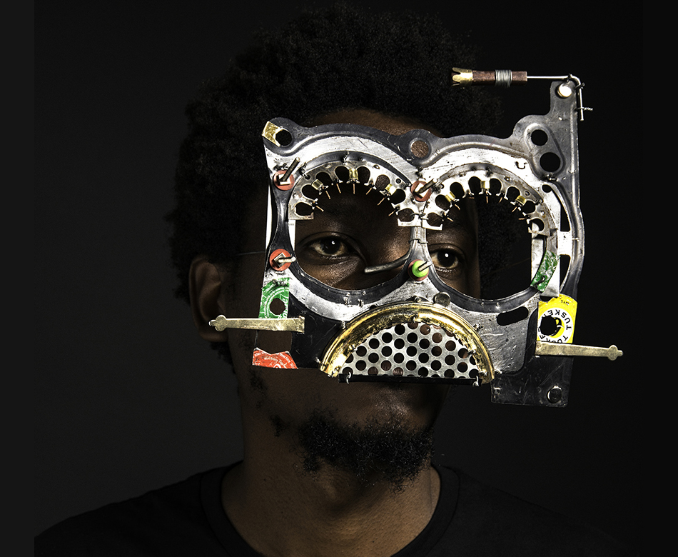 An African man wearing colourful glasses made from discarded car parts