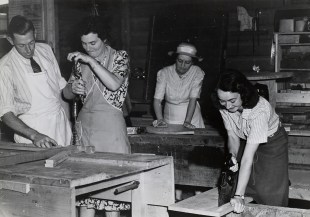 Sturt. Black and white image of several woman and a male teacher learning woodworking techniques.
