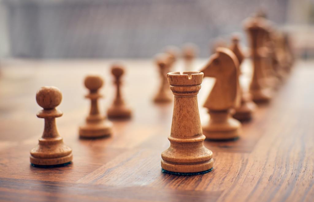 a close up of a chessboard with approximately 12 pieces on it