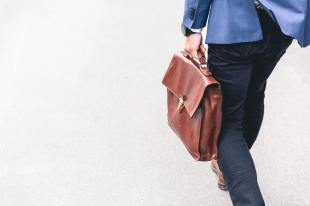 Man with bag walking away.