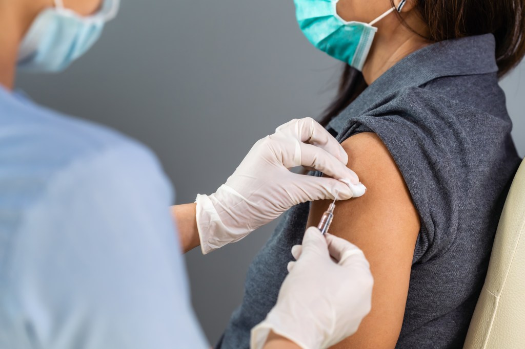 A woman is given a needle