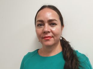 A woman in a green top against a white background