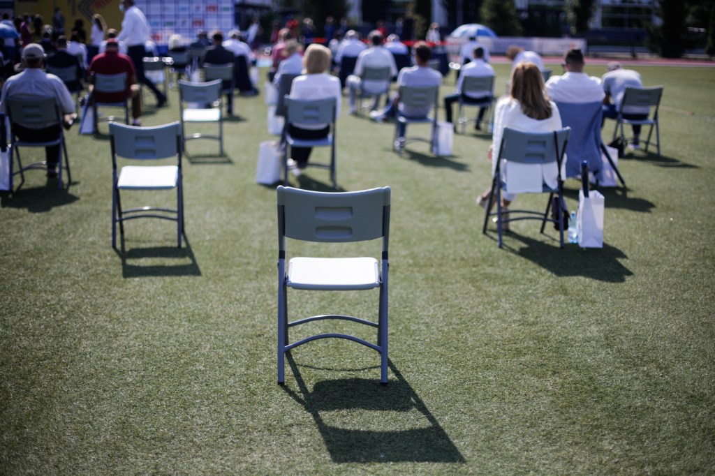 maintain the social distance during the Covid-19 outbreak at an outdoor event on the turf of a stadium.
