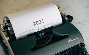 A typewriter with test on paper reading 2021