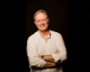 Antony Tulloch, a man in a patterned shirt with crossed arms