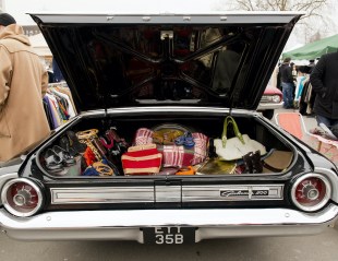 Open car boot at market sale.