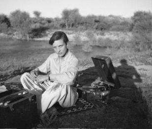 black and white image of a woman on a picnic rug