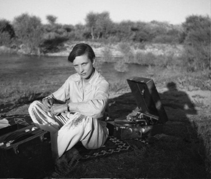 black and white image of a woman on a picnic rug