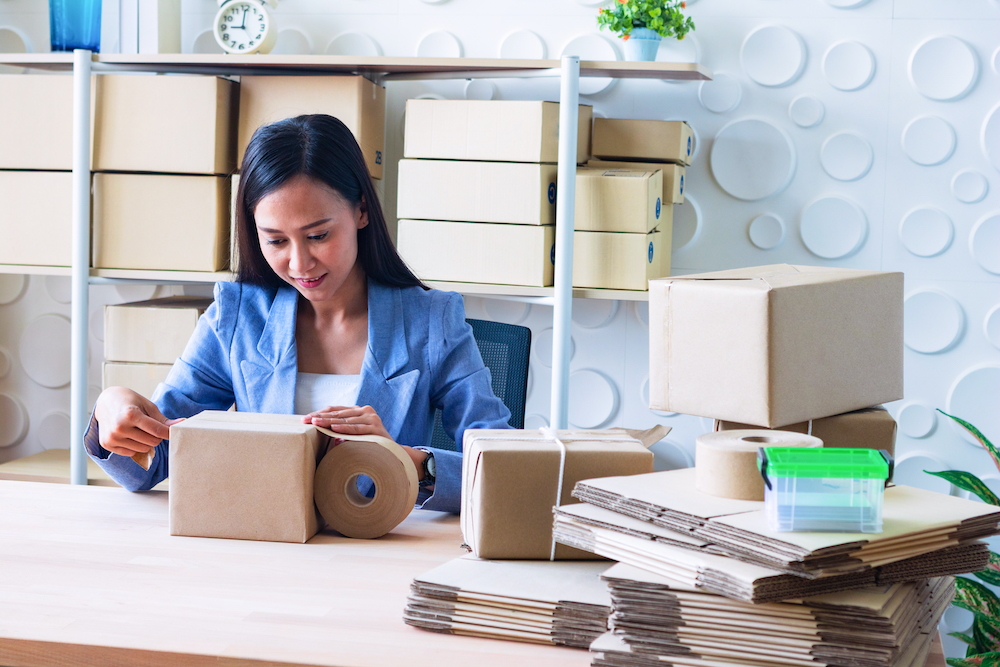 The young Asia Businesswoman makes parcel for online studio business.
