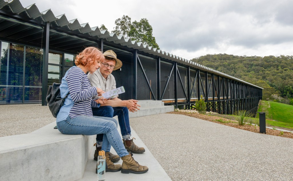 Man and a woman outside a bridge-like structure