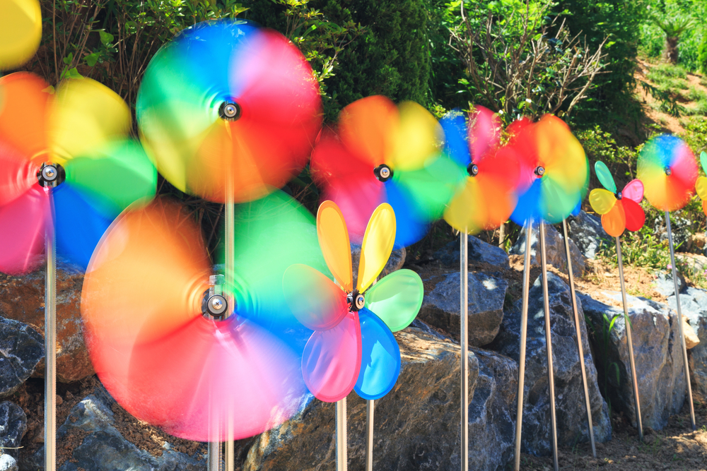 A colourful array of pinwheels spin in the breeze.