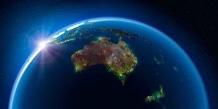 World globe with Australia in the foreground and a rising sun.