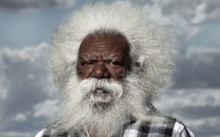a portrait of an Aboriginal man with white hair and a white beard.