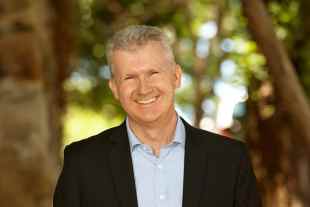 Tony Burke MP smiles at the camera.