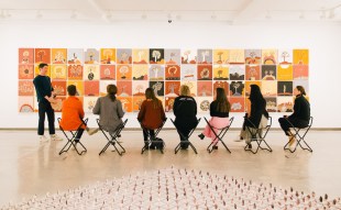 Visitors in discussion around a painting at MCA