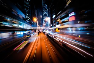 an abstract cityscape at night, with lines of light blurred to suggest fast movement.