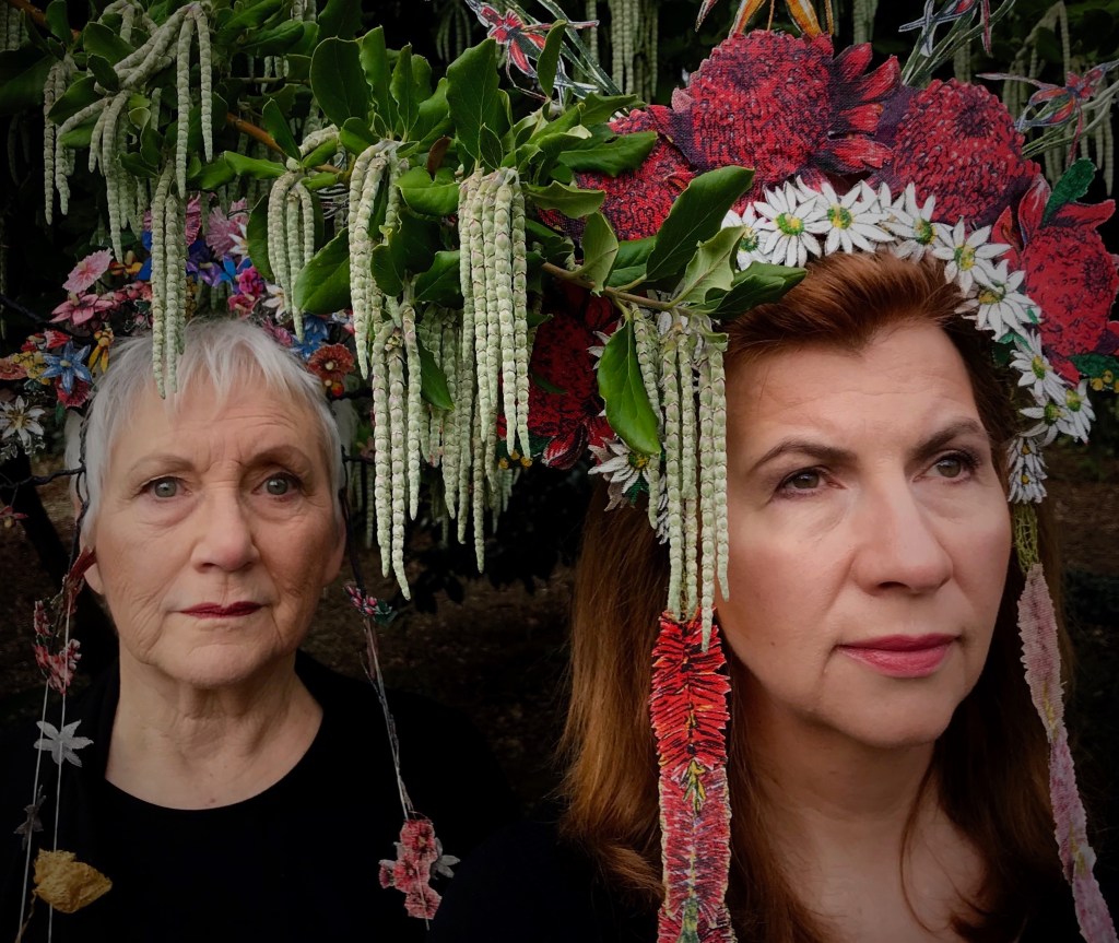 two mature dancers with floral headdresses