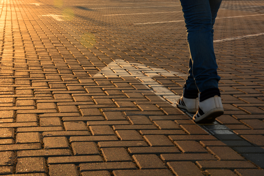 person walking in direction of arrows