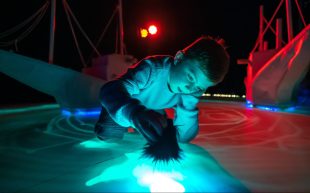 Young boy interacting with light art. arts education. DreamBIG