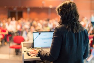 Business woman lecturing at Conference.