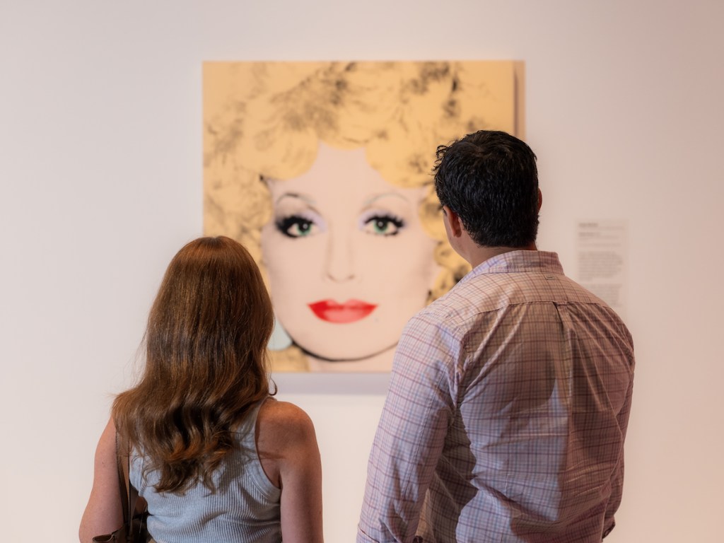Couple looking at Andy Warhol painting in gallery
