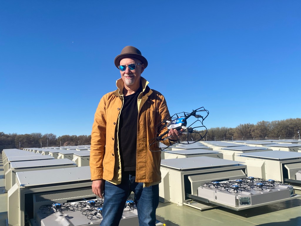 Light artist Bruce Ramus holding a drone