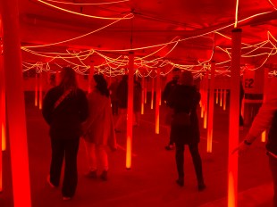 People in immersive red light art installation for Vivid Sydney.