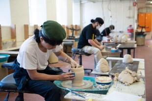 art student working on a pottery wheel