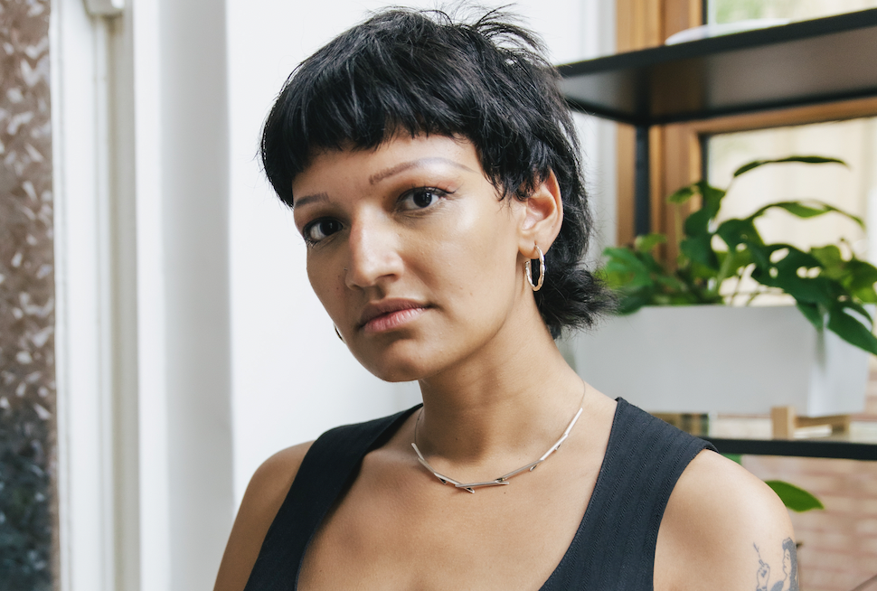 Head and shoulders shot of a young woman of Asian appearance looking at the camera.