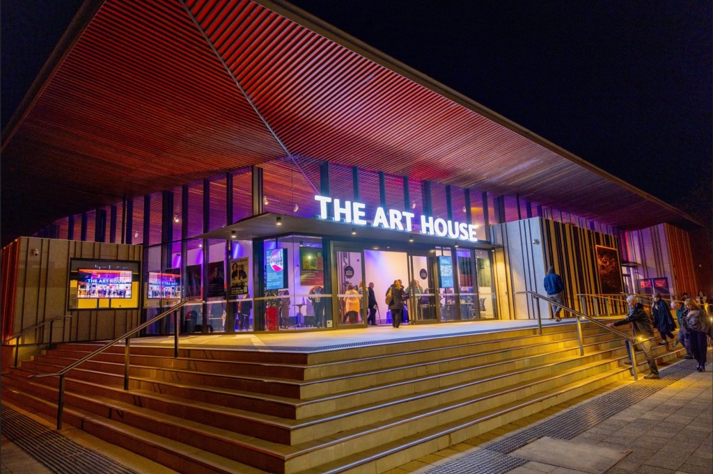 outside view of The Art House theatre with night lights on