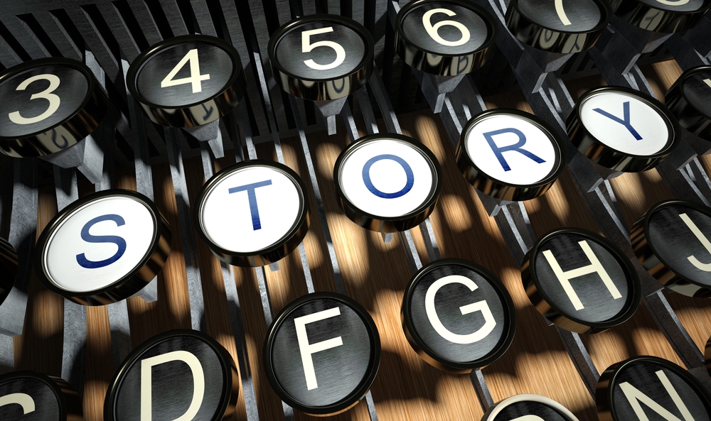 A close-up photo of a typewriter, the keys of which prominently display the word 'STORY' instead of the usual letters.