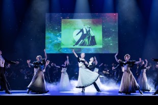 Strictly Gershwin. A number of ballet dancers pose mid dance in front of a film screen showing Fred Astaire and Ginger Rogers.