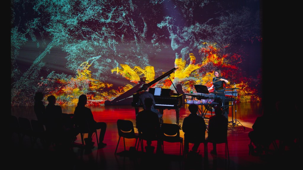 Conditions of Growth. Image show a backdrop of nature with four silhouettes in the foreground and a grand piano behind.