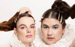 Melbourne Fringe. Two women with bustieres and frill collars, plus high ponytails face the camera.