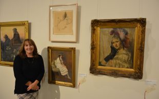 Adopt an Artwork. Jennifer Taylor, Registrar and Collections Manager at NERAM among some of the adopted artworks that are part of the 'Adopt An Artwork' exhibition currently on at NERAM. Photo: Supplied.