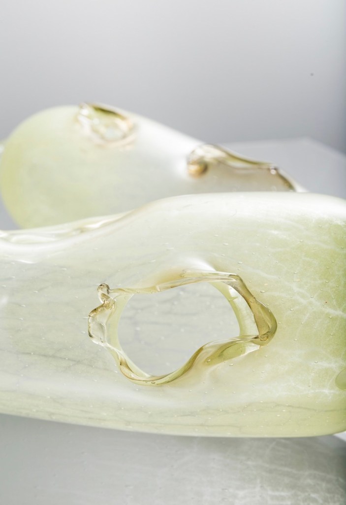 detailed image of a piece of soft green glass which has been formed into an pillow shape by artist Yhonnie Scarce