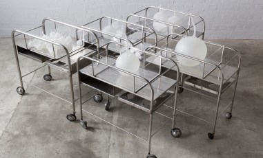 metal trolleys with white handblown glass elements on top as part of art installation