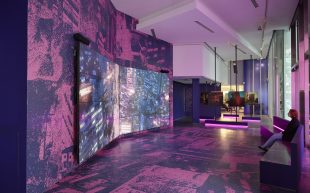 Liam Young. Image shows room with purple hues and large screens angled away from the viewer.