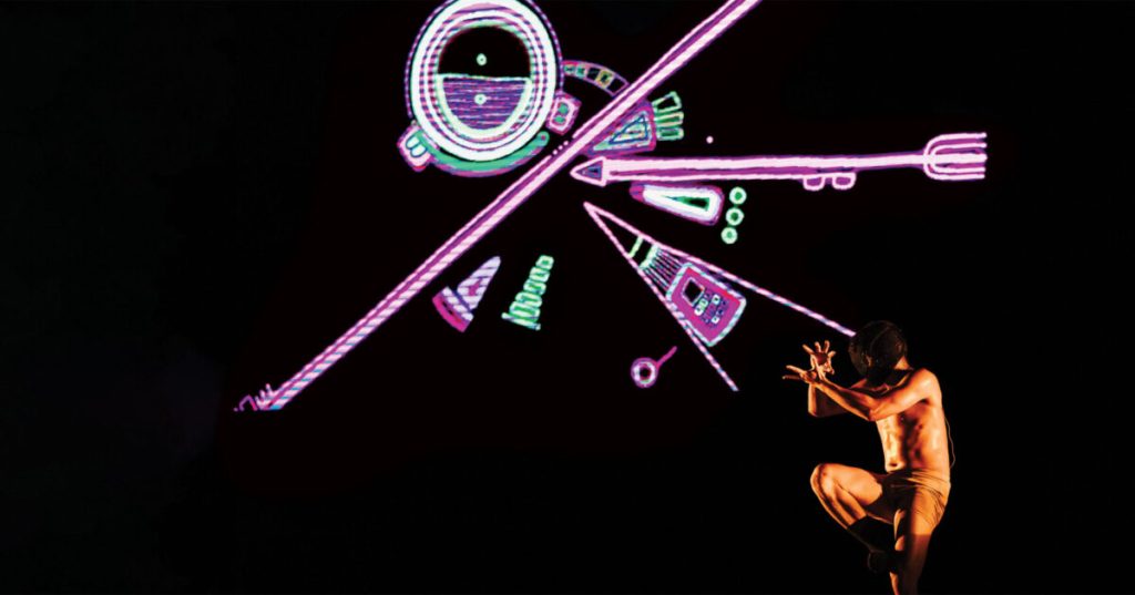 tiaen tiamen. Image is abstract purple and green laser lighting patterns on black background with a crouching dancer wearing a loincloth and looking backwards in the bottom right hand corner