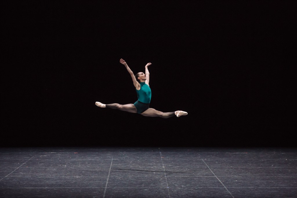 arts appointments. Image is a leaping female ballet dancer with legs in a perfect mid air split.