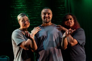 Daylight Connection. Image is an Aboriginal man flanked by two Aboriginal women whoh each have a hand on his shoulder. All are wearing grey T shirts.