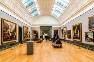 Interior view of a gallery space at the Tate Britain museum showing a series of 17th century oil paintings in decorative frames.