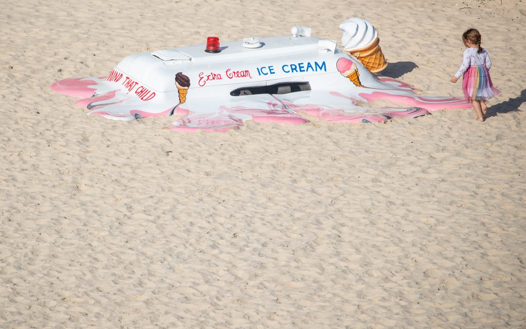 opportunities and awards.Image is an artwork sculpture of an ice cream van which has melted into the sand.