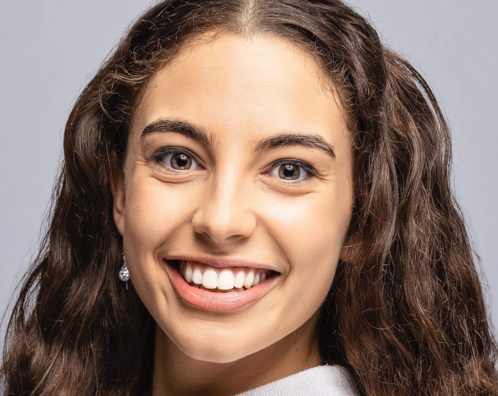 Annmarie Clifton-James headshot of young woman with light brown skin and long dark hair smiling as she studies dance at WAAPA.