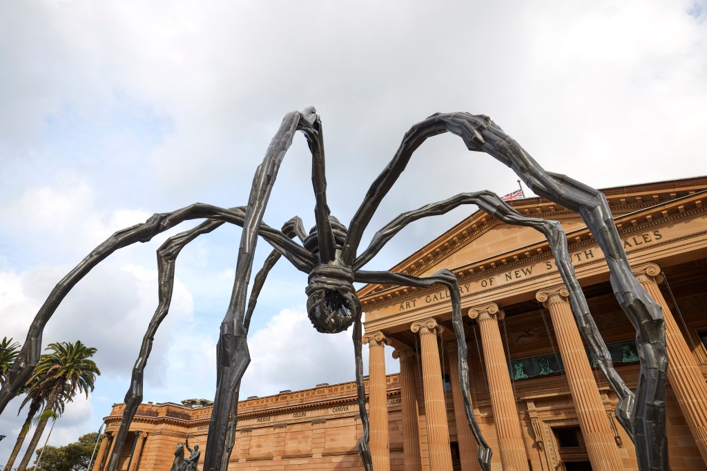 Louise Bourgeois. Image is a huge bronze spider taking up the forecourt of an art gallery with columns in the front.