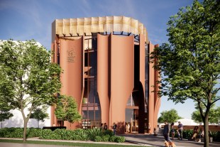 Artist impression, Vietnamese Museum Australia. Image: Architecture render by Konzepte Melbourne, Supplied. A terracotta-coloured architecture shaped like a round-edged square. Text on the building says 'Vietnamese Museum Australia'. People are seen outside the museum with trees in the foreground and background of a urban landscape.