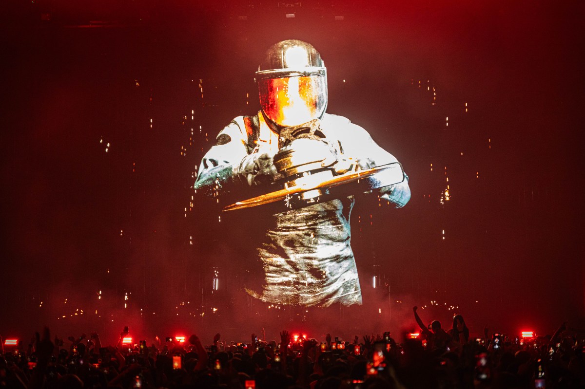 Prydz. Image is a human in a space suit projected on a huge screen in front of a dancing crowd.