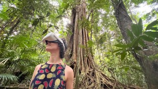 Gondwana. Image is rainforest and a young woman in a sleeveless patterned dress wearing a VR headset.